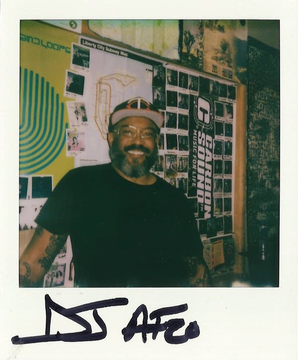 a man posing for a polaroid photo