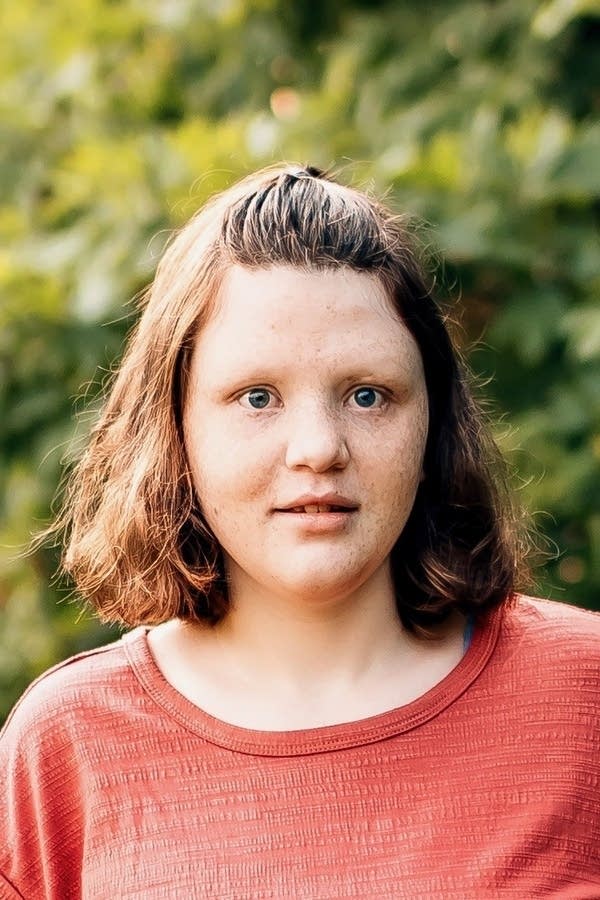 A headshot of Taylor Arndt with trees in the background