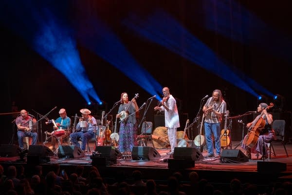 A large group of musicians performing together onstage