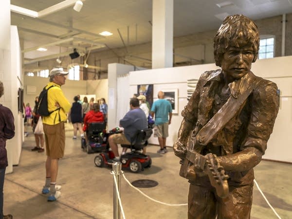 People are visiting an exhibition of paintings 