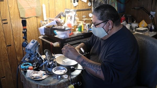  JJ Otero, a Navajo and Hopi silversmith, working in his studio.