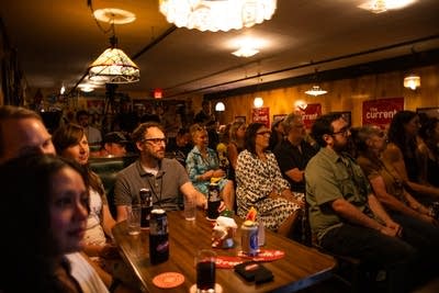 Music fans listen to a performance in a small music venue