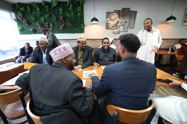 A group of people gathers in a cafe.