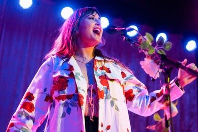 Jess Williamson sings while wearing a rose-printed blazer