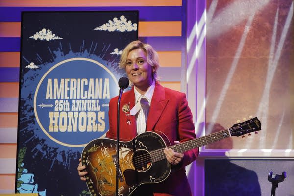 A musician speaks after winning an award