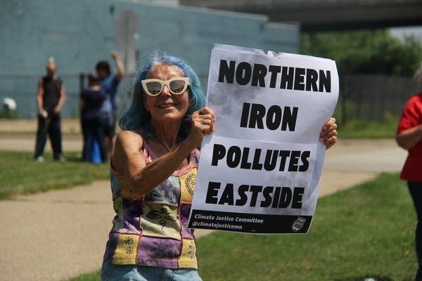 People protest near a foundry in the neighborhood.