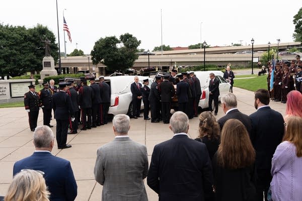 caskets being loaded into hearse2