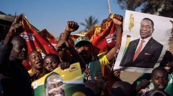 Supporters of the newly reelected Zimbabwe President Emmerson Mnangagwa celebrate in Mbare, Harare, on August 3, 2018.