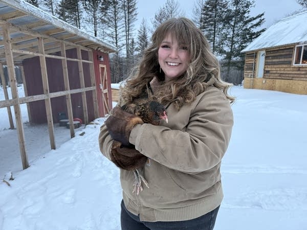 woman holding a chicken 