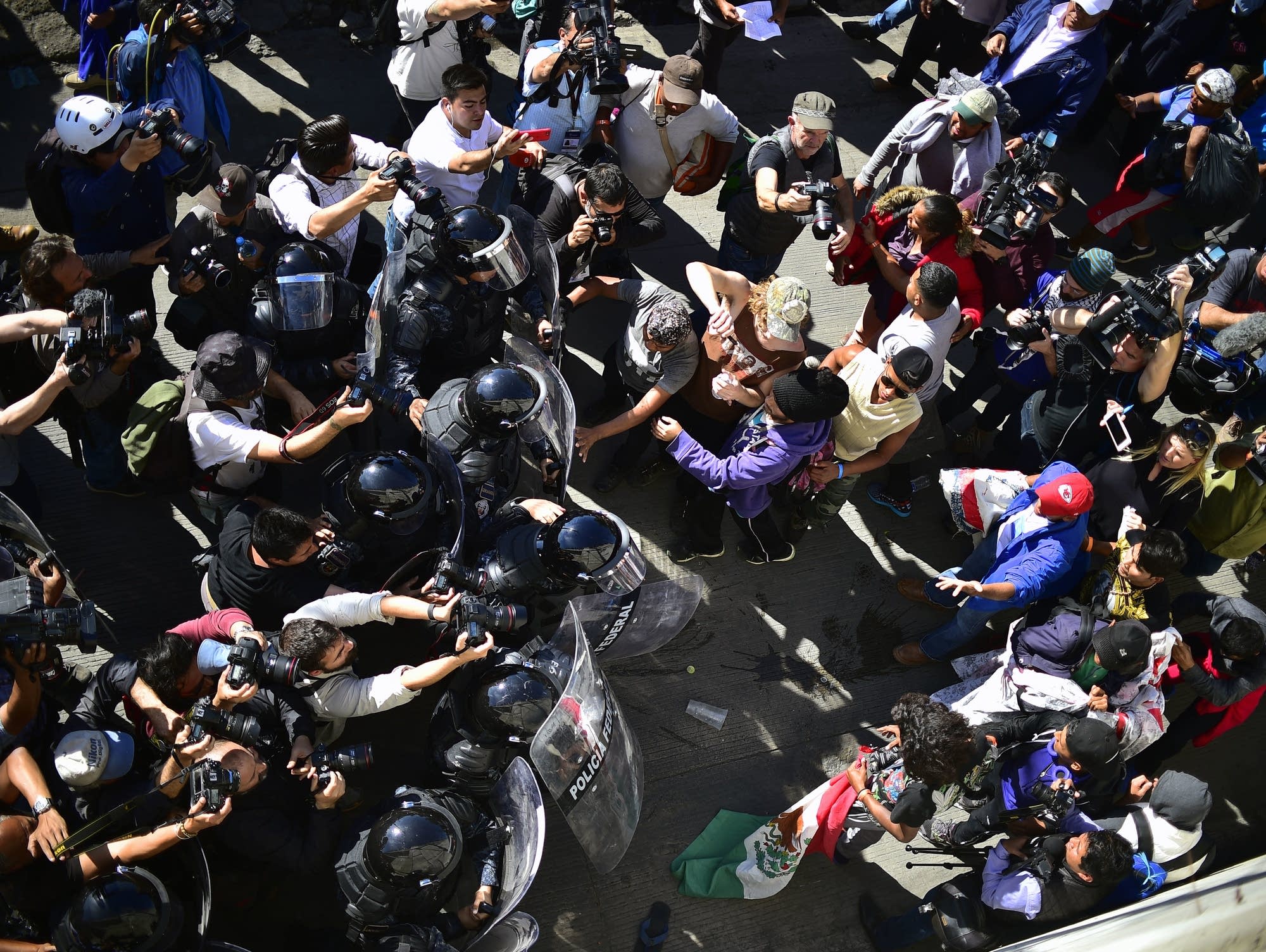 Central American migrants are stopped by federal police officers