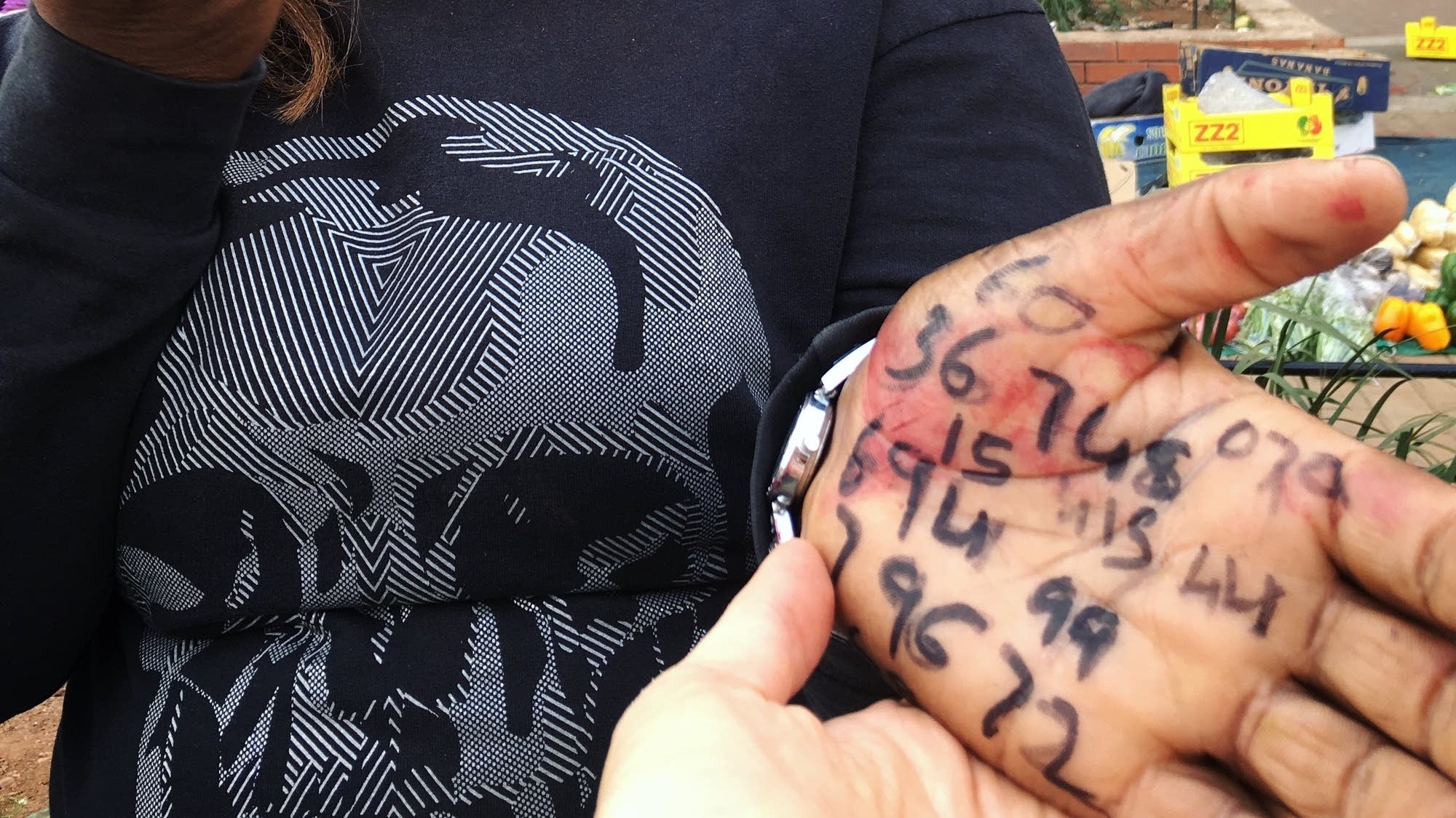 A fruit-seller records the license plate numbers of customers.