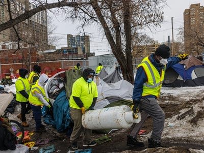 Crews of state and county workers clear a large homeless encampment