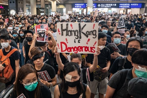 Protesters occupy the arrival hall of the Hong Kong International Airport during a demonstration on August 12, 2019 in Hong Kong, China. Pro-democracy protesters have continued rallies on the streets of Hong Kong against a controversial extradition bill since 9 June as the city plunged into crisis after waves of demonstrations and several violent clashes. Hong Kong's Chief Executive Carrie Lam apologized for introducing the bill and declared it "dead", however protesters have continued to draw large crowds with demands for Lam's resignation and completely withdraw the bill. (Photo by Anthony Kwan/Getty Images)