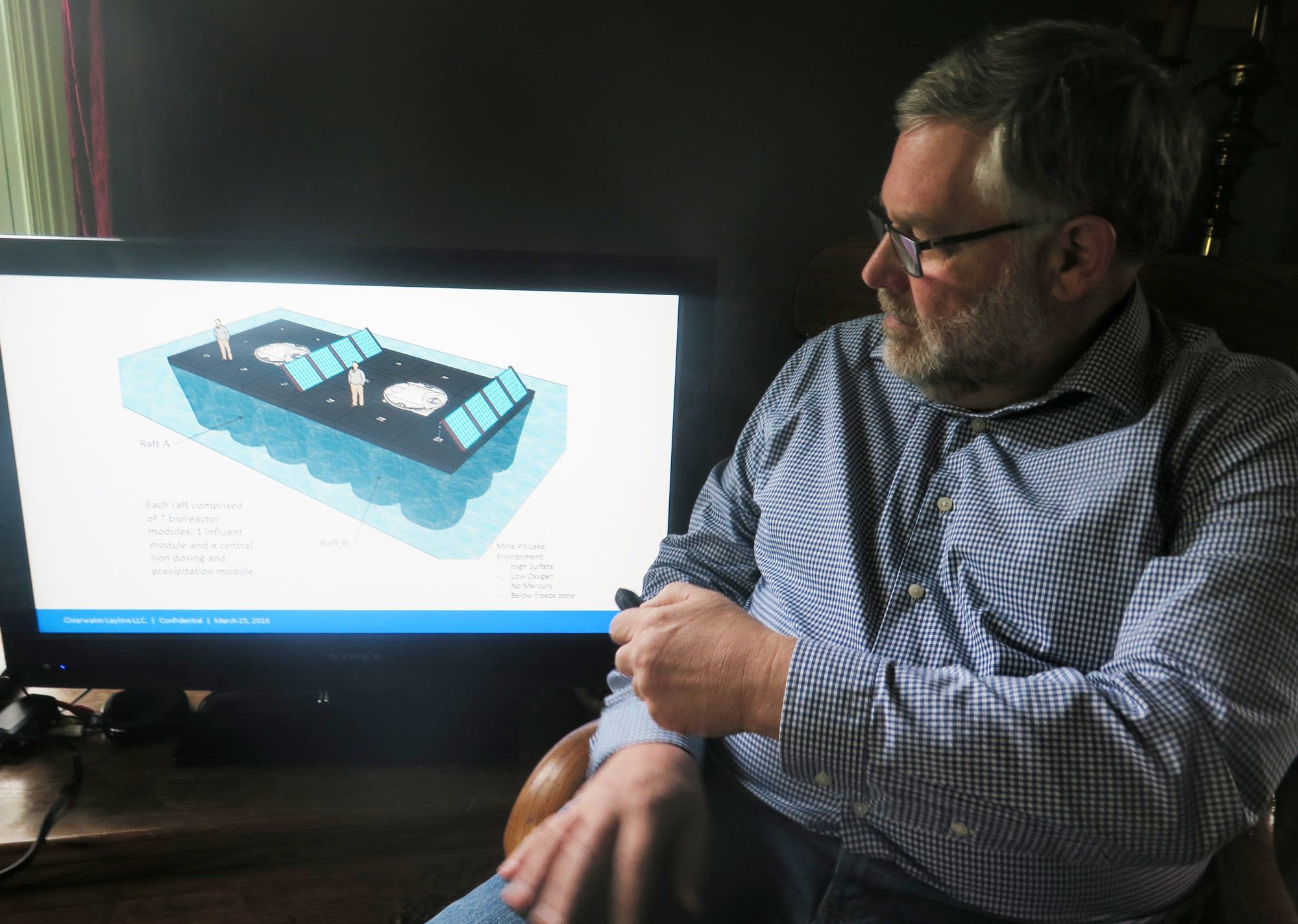 Jeff Hanson, an environmental engineer, displays a water treatment system.