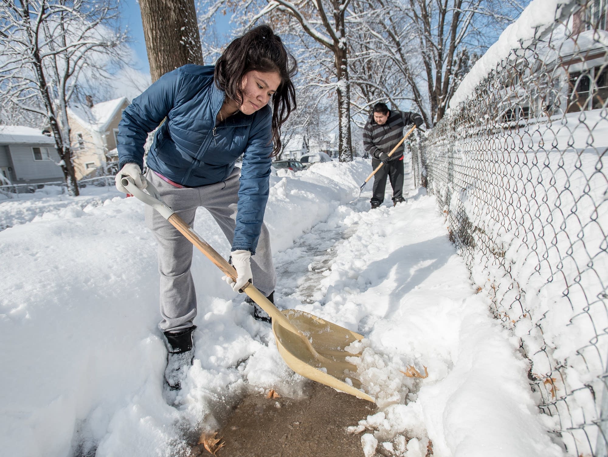 Joanna Peralta, 14, and her father Reme Peralta, 35, shovel the snow