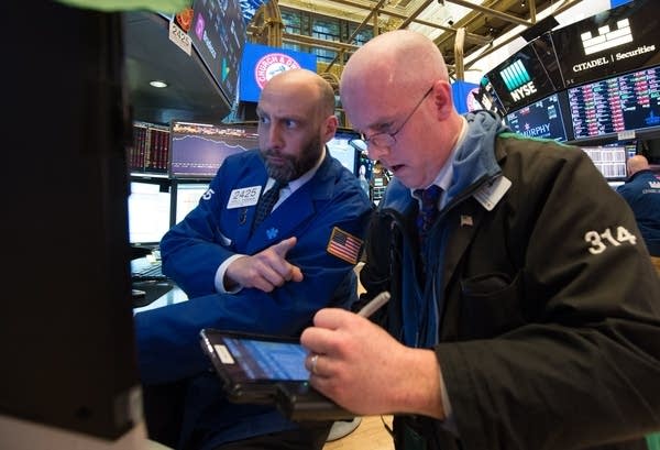 Traders work on the floor at the New York Stock Exchange.