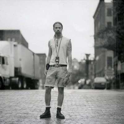 Brian Garrity stands on a cobblestone street.