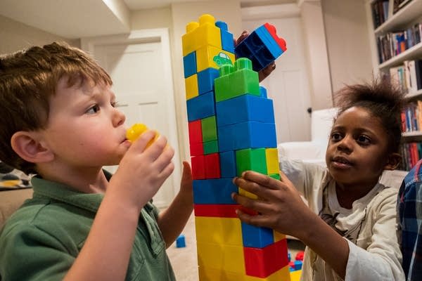 Luca Choudry and Esther Mphiri build a block tower together. 