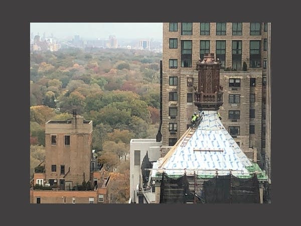 Workers atop a roof in New York City