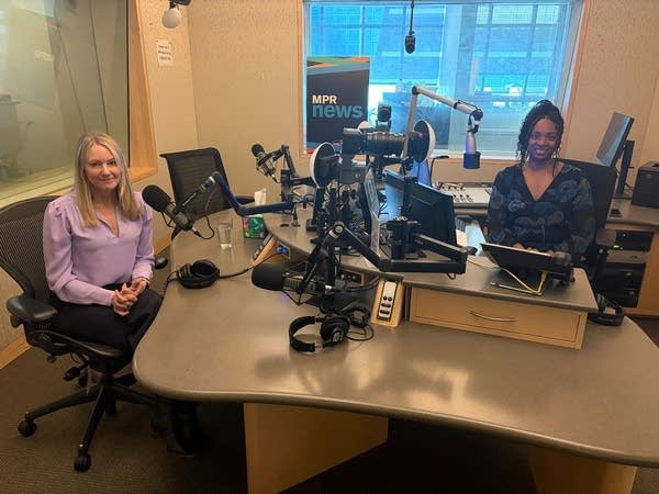 Two women smiling in a broadcast studio