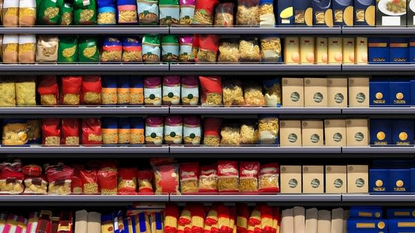 An illustration of spaghetti, fusilli, and lasagna packagings on a shelf at a supermarket.