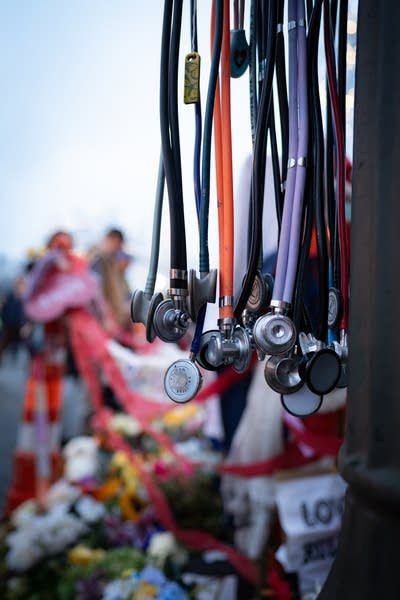 stethoscopes hang on a memorial