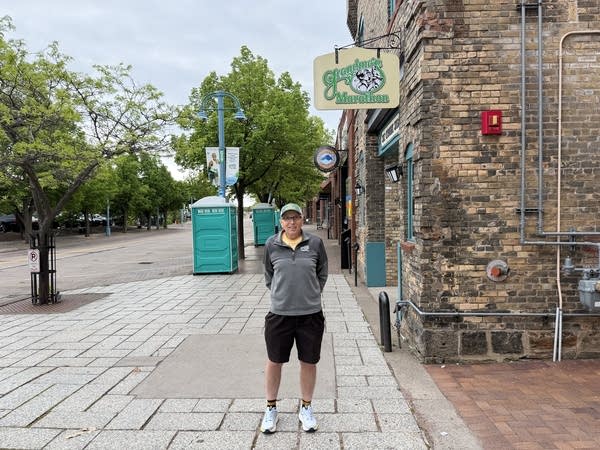 A person stands in front of the marathon's offices in Duluth