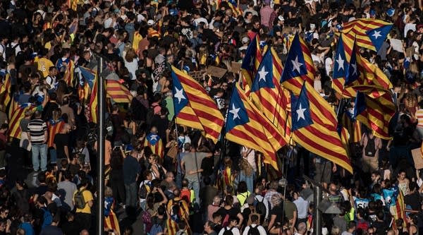 People wave Catalan Pro-Independence flags known as 'Estelada' during a regional general strike to protest against the violence that marred Sunday's referendum vote on October 3, 2017 in Barcelona, Spain.