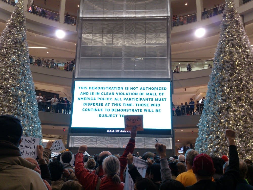 MOA officials flashed a sign at protesters.