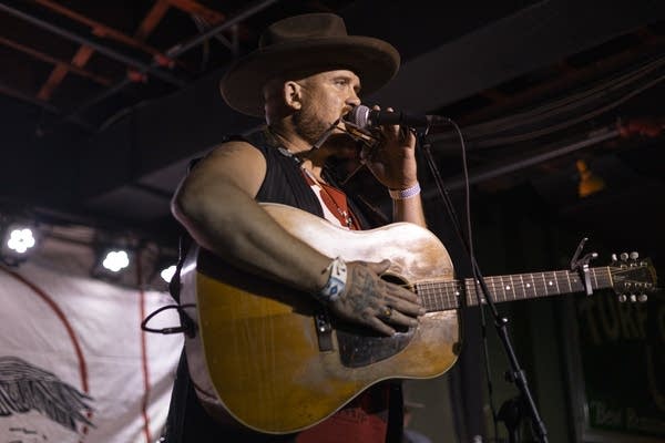 A person plays guitar on stage
