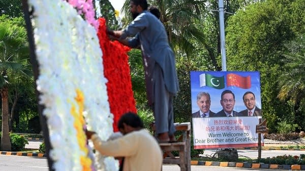 Workers in Islamabad decorate a street ahead of a Shanghai Cooperation Organisation summit.