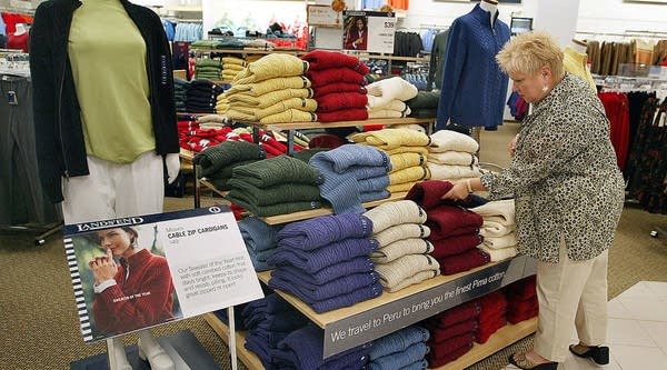 A woman shops for Lands' End brand sweaters October 15, 2003 at a Sears store in Niles, Illinois.