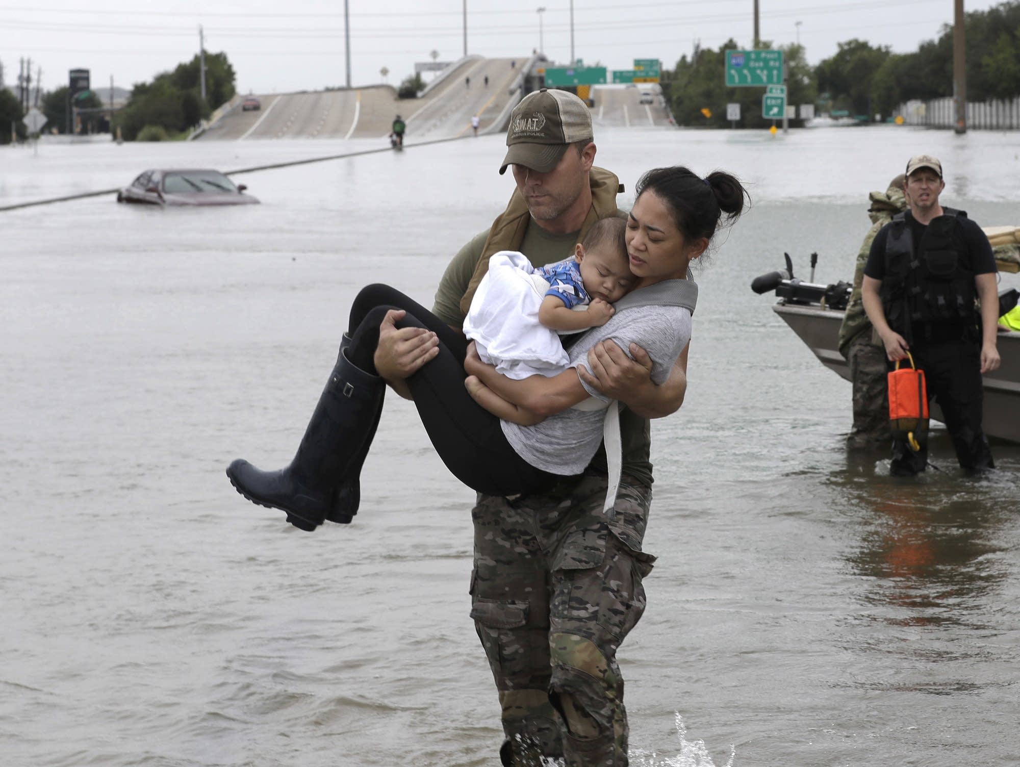 A Houston Police SWAT officer carried a woman and her son