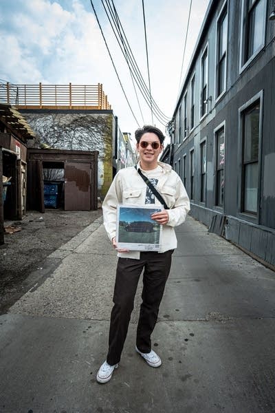 Person holding Kendrick Lamar record outdoors