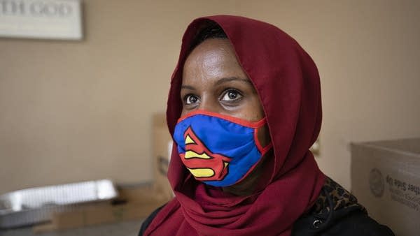 A person wears a Superman mask.