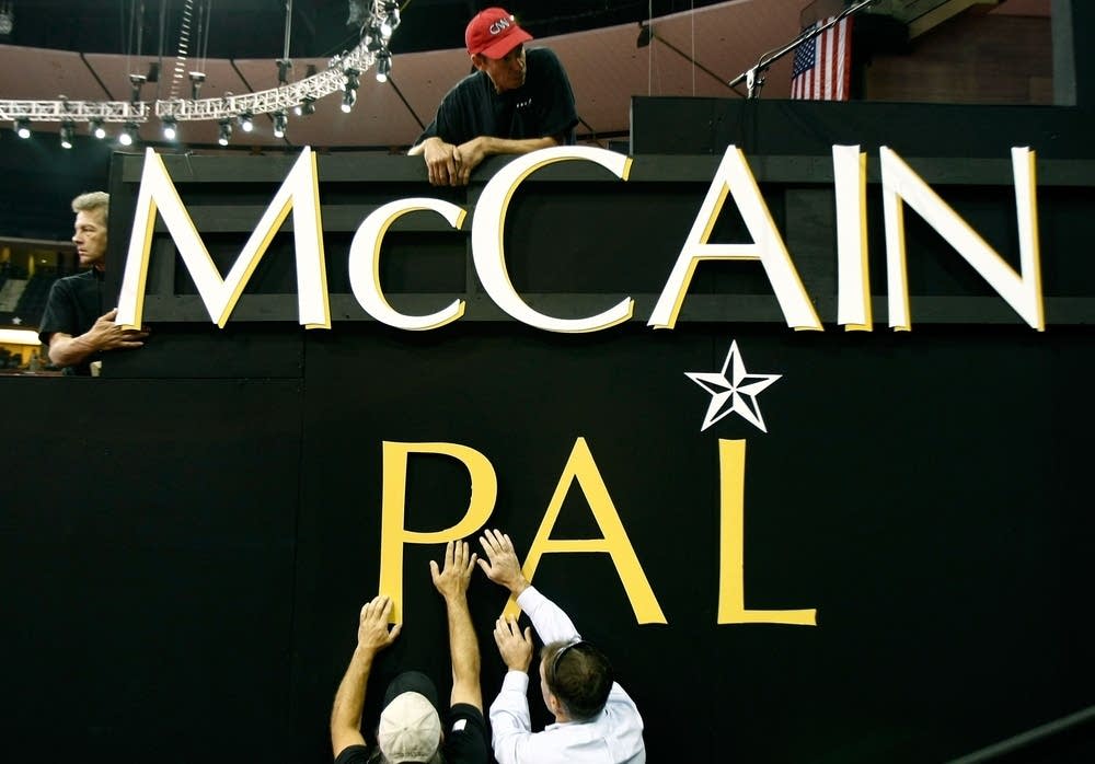 Workers hang letters at the RNC.