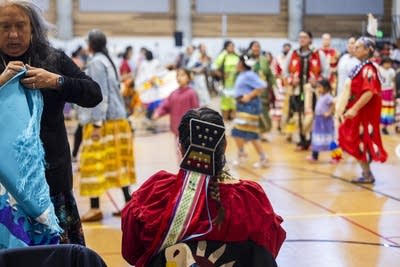 A dancer watches others perform.