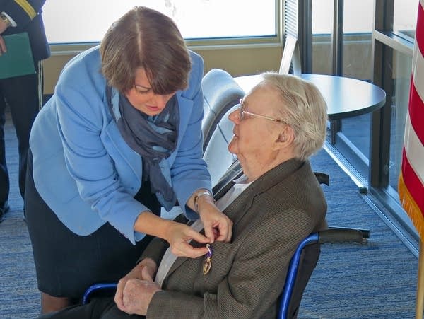 Sen. Amy Klobuchar pinned  a the Purple Heart on WWII vet Wayne Sundberg.