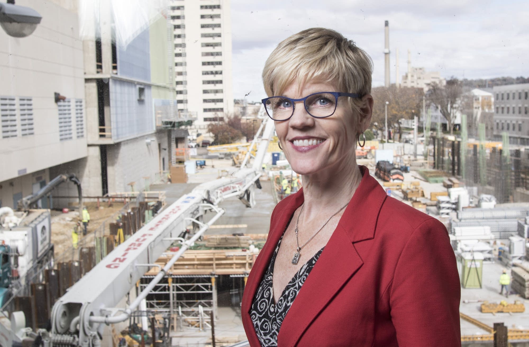 Lisa Clarke stands in a skyway overlooking Hilton Hotel construction.