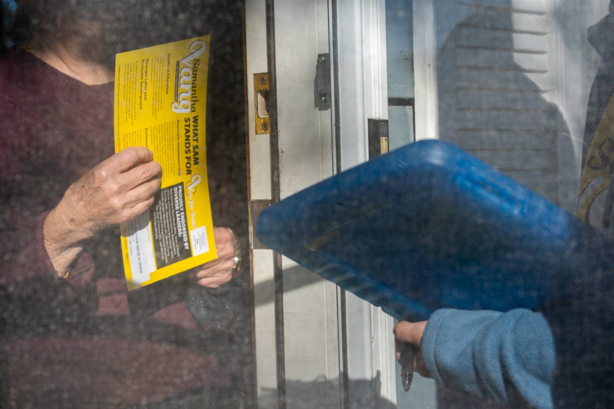 A Brooklyn Center resident holds on to a flier