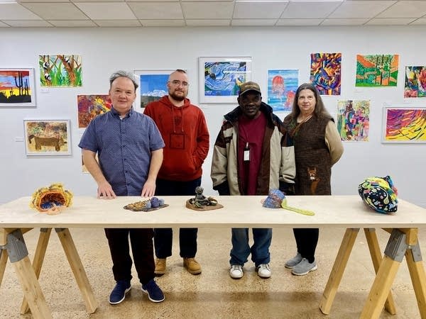 artists posing for photo in interact gallery