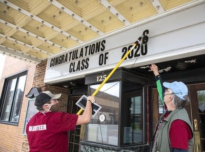 Person changes letters on a marquee. 