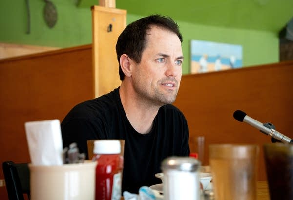 a man talks into a microphone