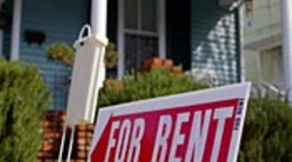 For Rent sign in front of house.