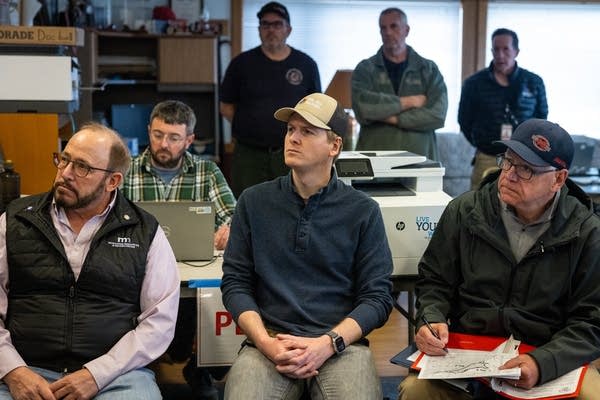 Elected officials listen during a briefing