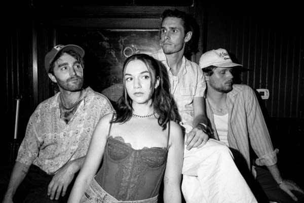 Four people sit together for a group portrait