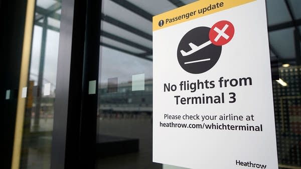 A sign alerts travels to the closure of Terminal 3 at Heathrow Airport in west London on Dec. 21, 2020, as a string of countries around the world banned travelers arriving from the U.K., due to the rapid spread of a new, more-infectious coronavirus strain.