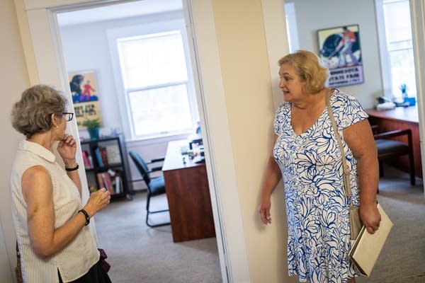 Two women stand in a hall