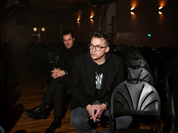 Ant and Slug sit in a darkened theater on chairs.