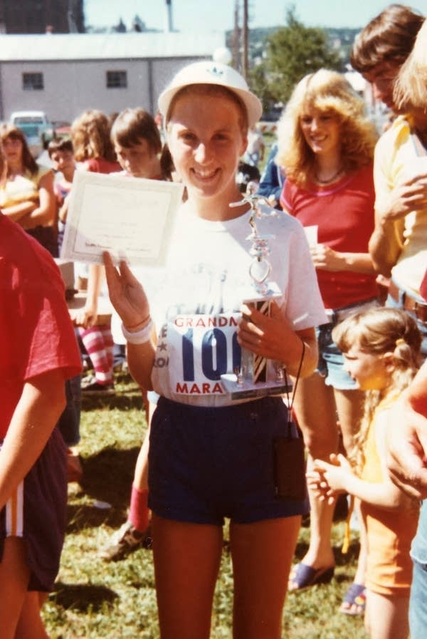 A woman holds trophy
